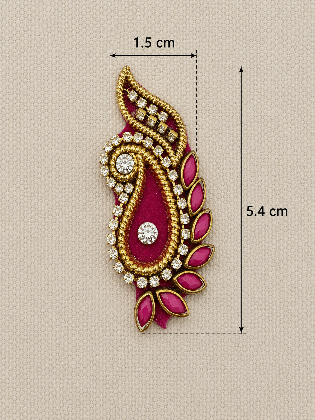 Decorative gold and pink embellishment with measurements on a beige background