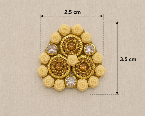 Gold brooch with floral elements and gemstones, shown with measurements on a beige background