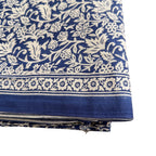 Blue fabric with white floral pattern on a white background
