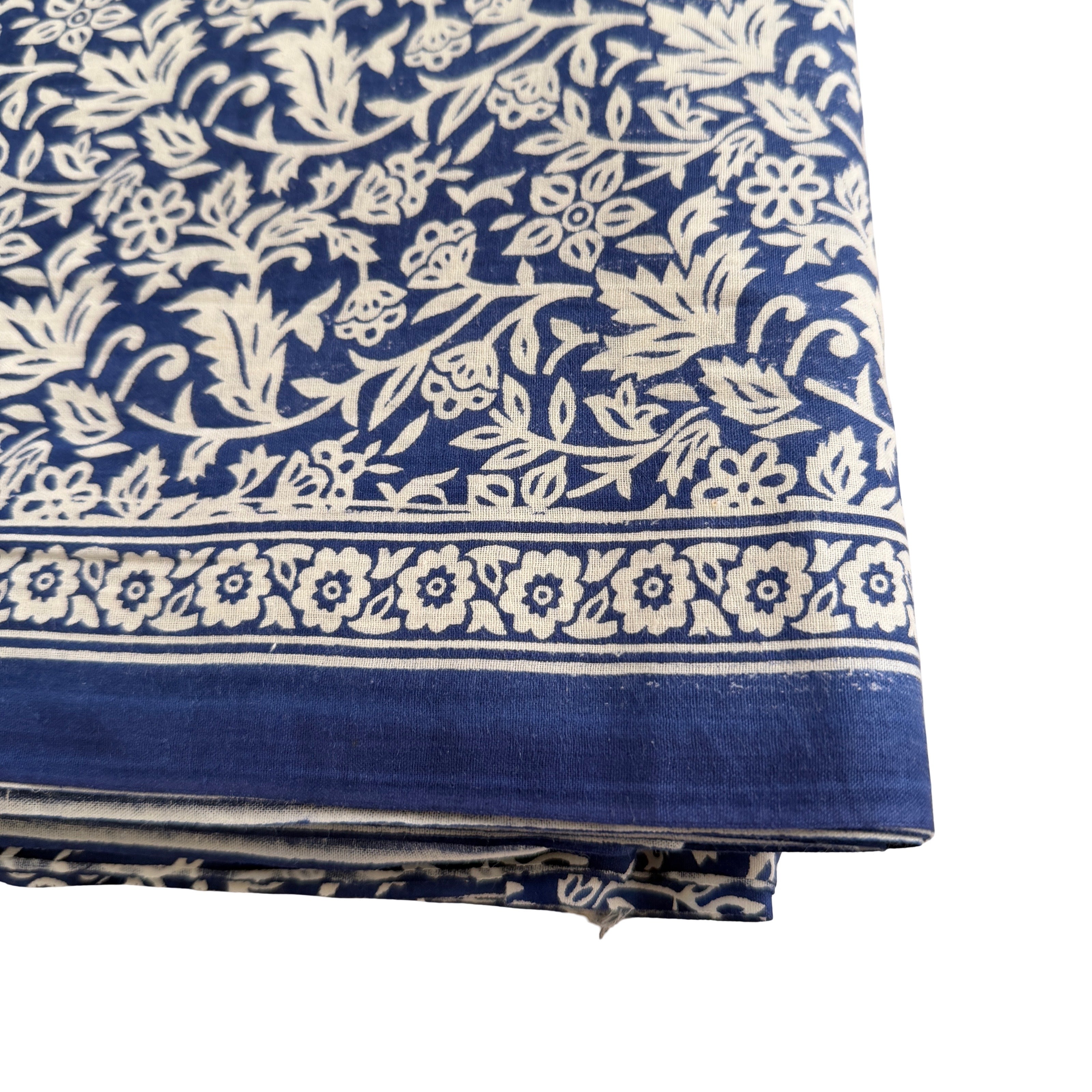 Blue fabric with white floral pattern on a white background