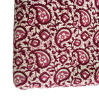 Fabric with red and beige paisley pattern on a white background