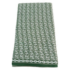 Green and white patterned towel on a white background