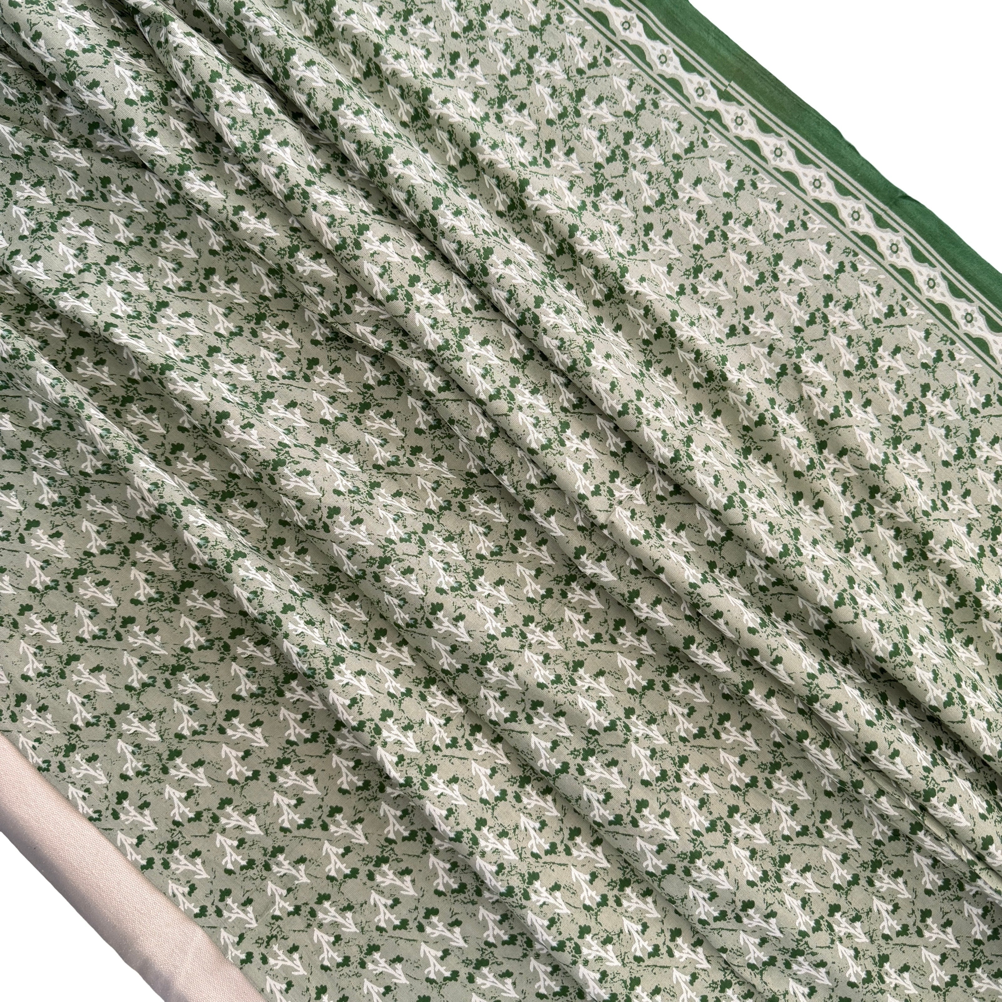 Close-up of floral patterned fabric with green border