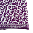 Close-up of a fabric with purple floral pattern on a white background