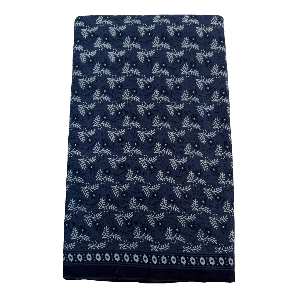 Navy blue towel with white floral pattern on a white background