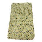 Folded fabric with small floral pattern on a white background