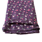 Folded Wine fabric with floral pattern on a white background