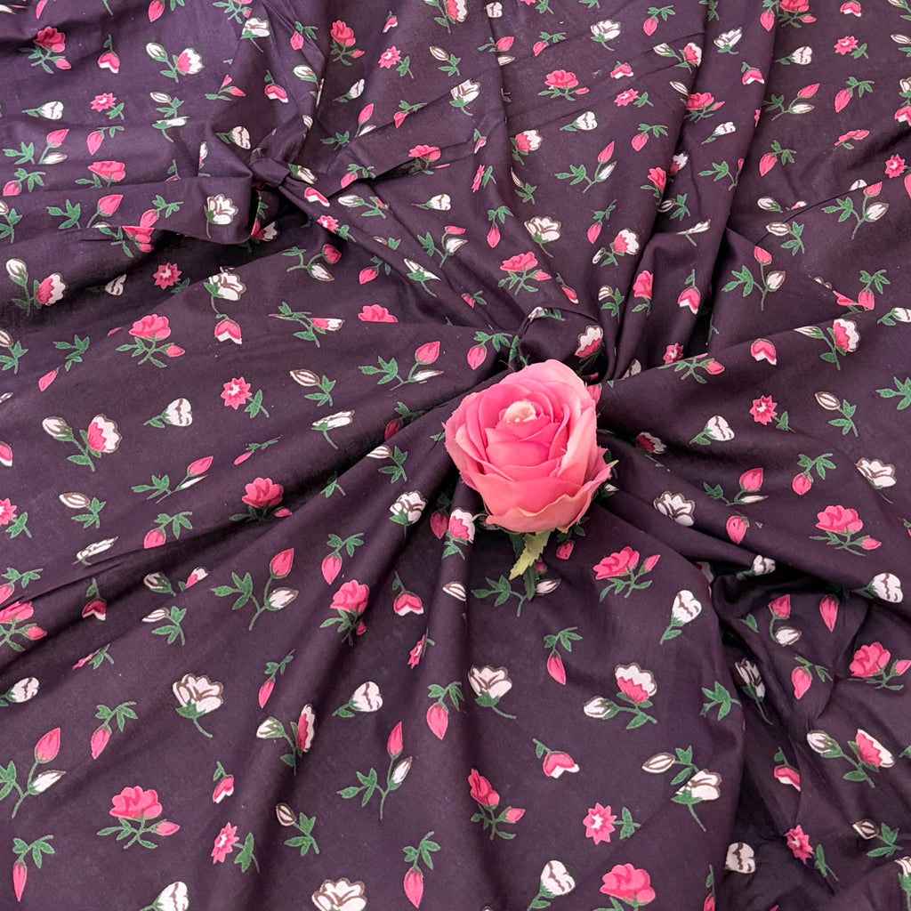 Floral fabric with pink roses on a dark background