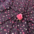 Floral fabric with pink roses on a dark background