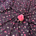 Floral fabric with pink roses on a dark background