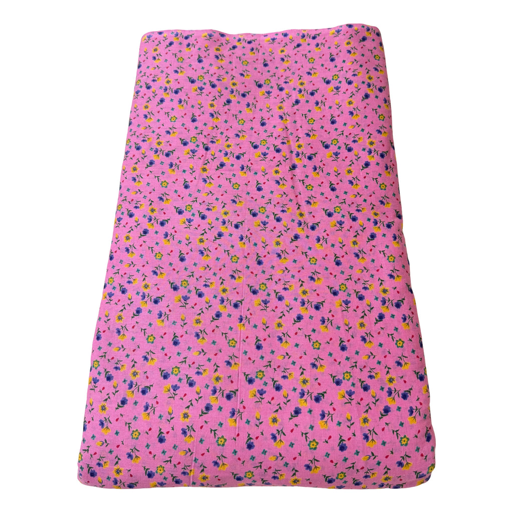 Pink fabric with small floral pattern on a white background