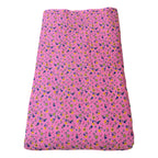 Pink fabric with small floral pattern on a white background