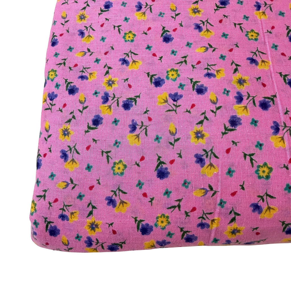 Pink fabric with small colorful floral pattern