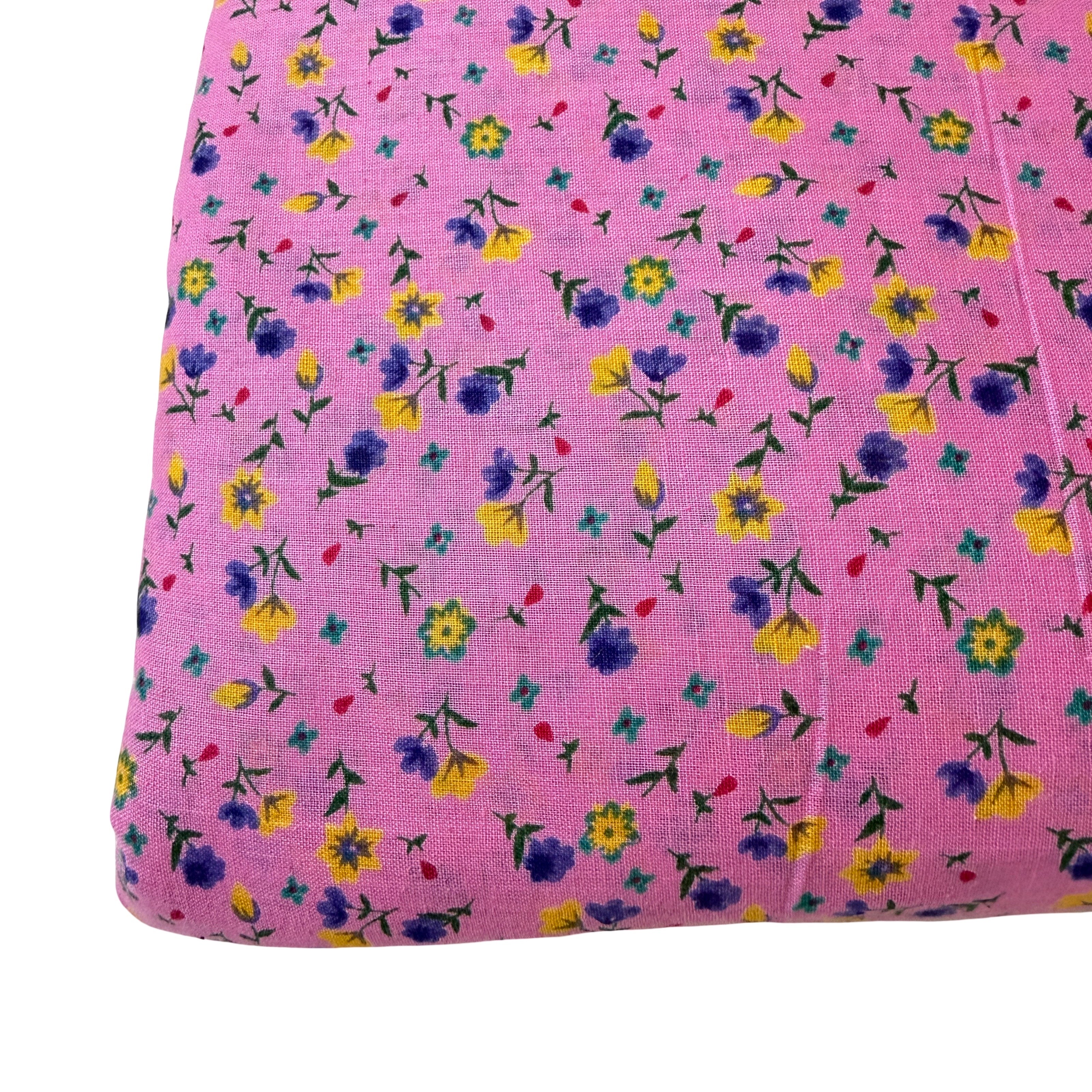 Pink fabric with small colorful floral pattern