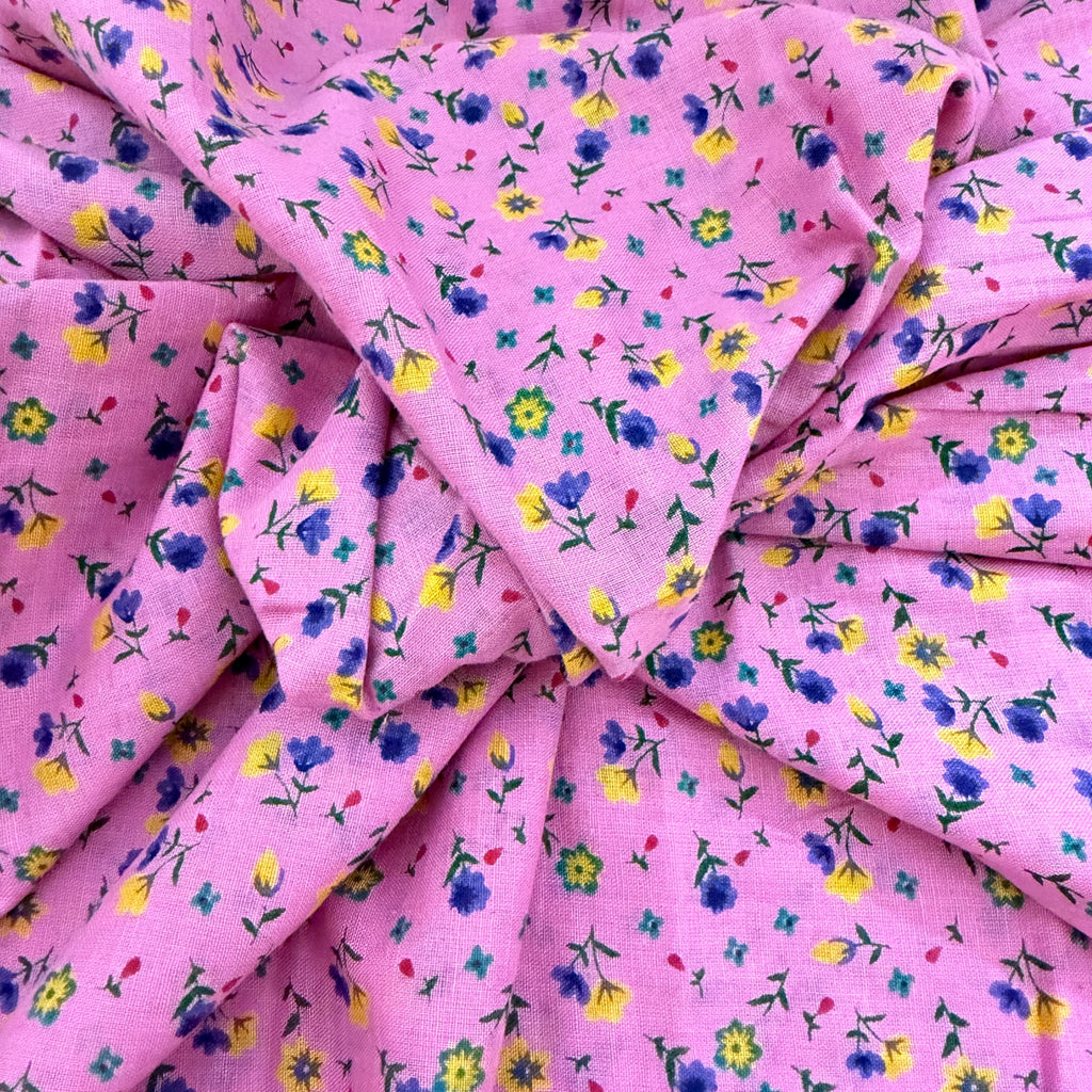 Pink fabric with small colorful floral pattern