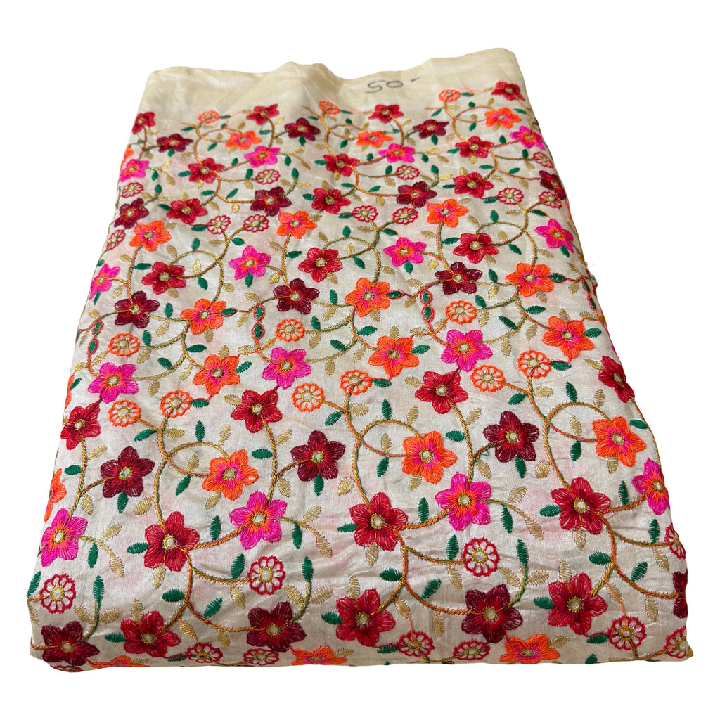 Embroidered fabric with colorful floral pattern on a white background