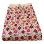 Embroidered fabric with colorful floral pattern on a white background