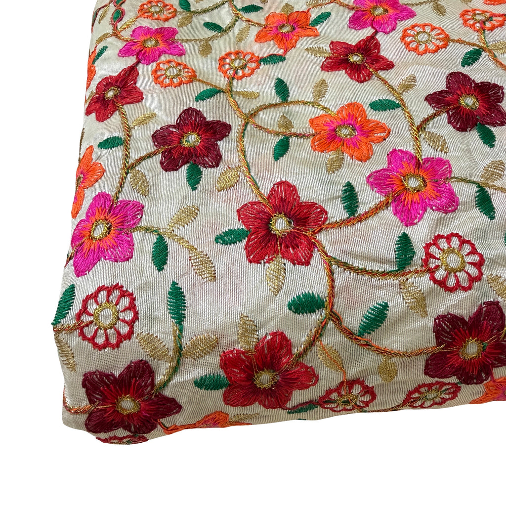 Embroidered fabric with colorful floral patterns on a beige background