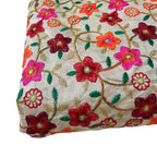 Embroidered fabric with colorful floral patterns on a beige background