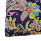 Embroidered fabric with colorful paisley patterns on a dark background