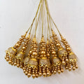 Gold beaded tassels on a white background