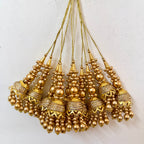 Gold beaded tassels on a white background