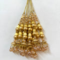 Gold and pearl beaded hanging ornament on a white background
