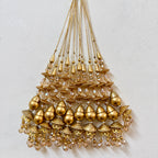 Gold beaded chandelier on a light gray background
