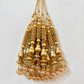 Gold beaded chandelier on a light gray background