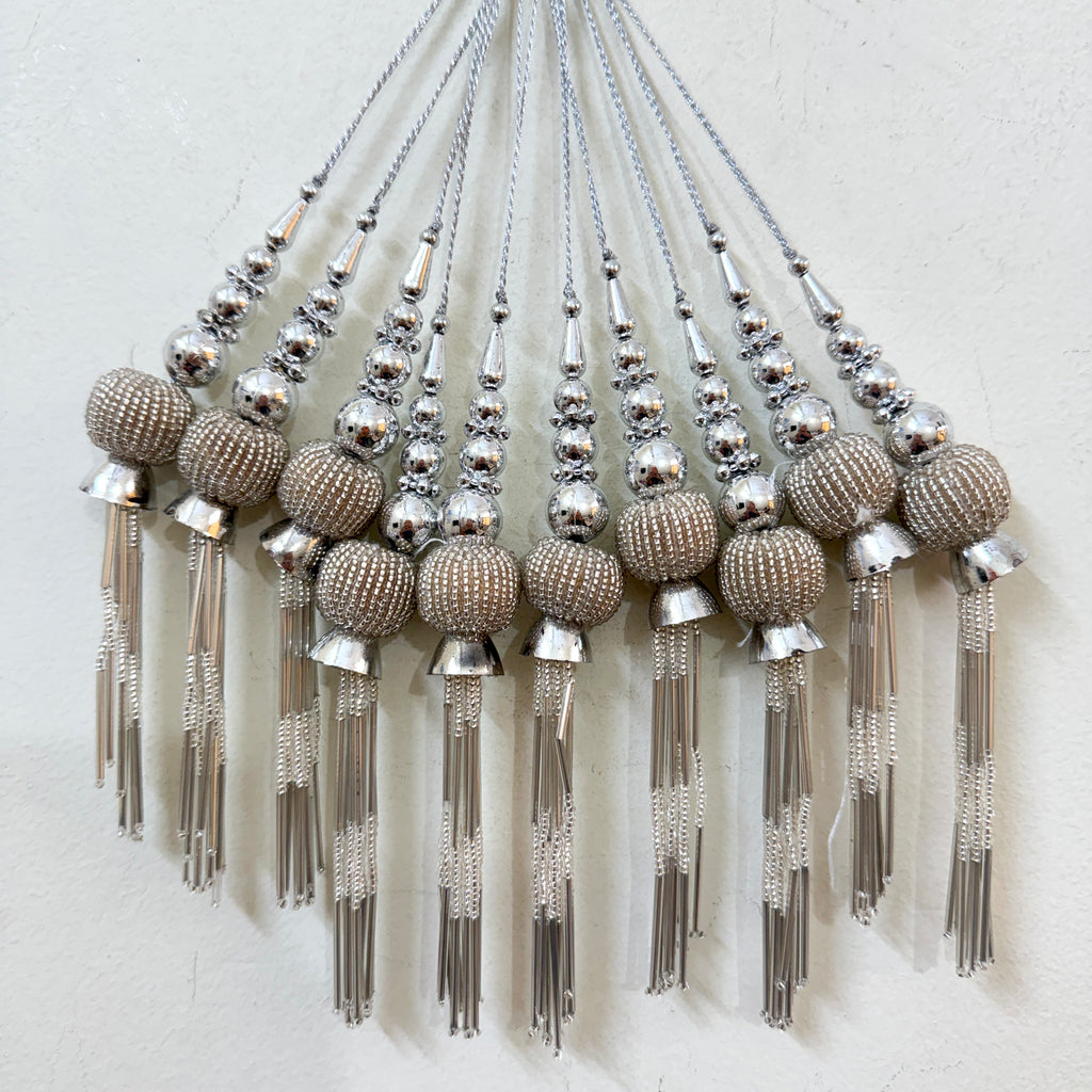 Decorative tassels with beads on a white background
