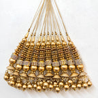 Gold necklace with beads and pendants on a white background