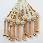 Decorative hanging beads with gold and beige colors on a white background