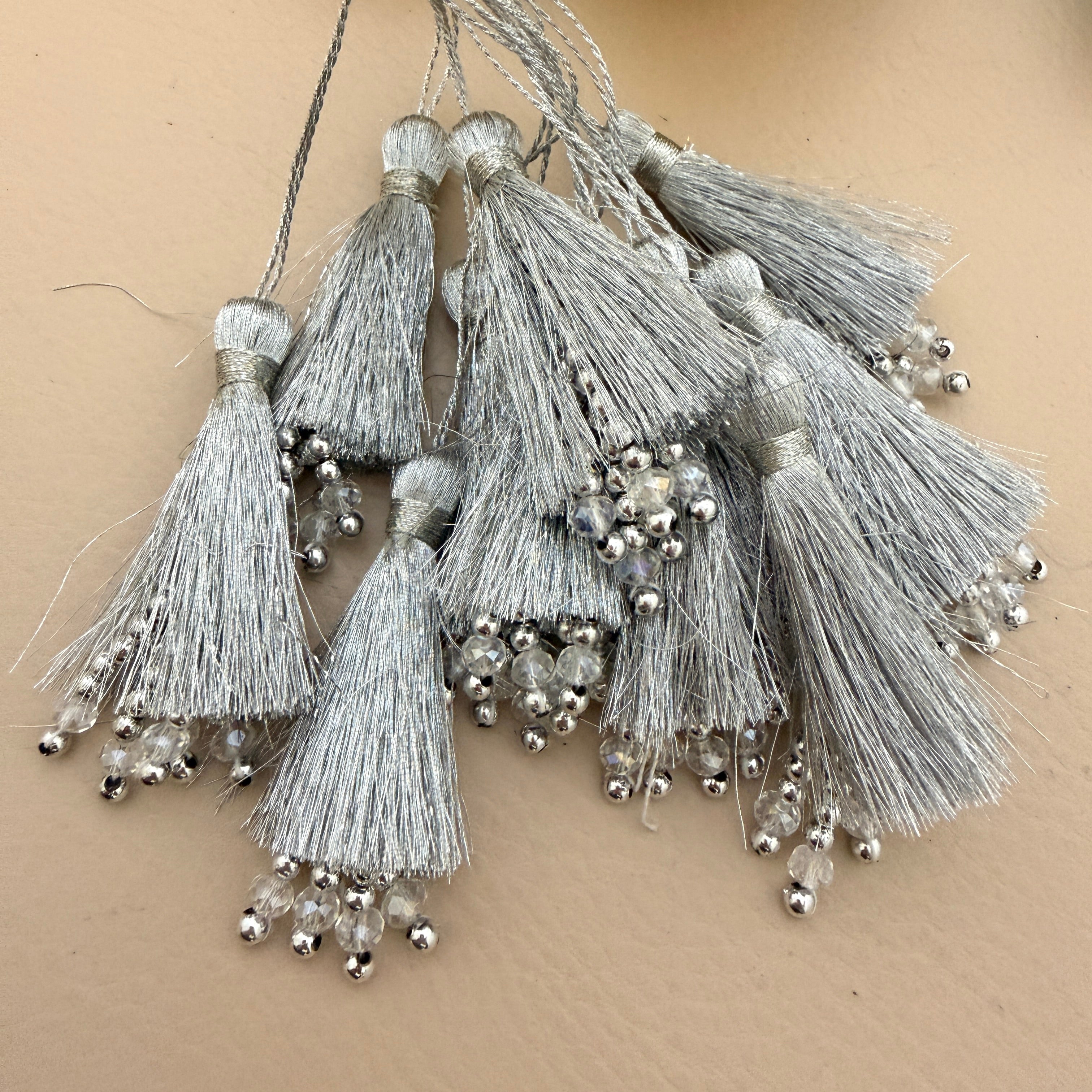 Decorative tassels with beads on a beige background