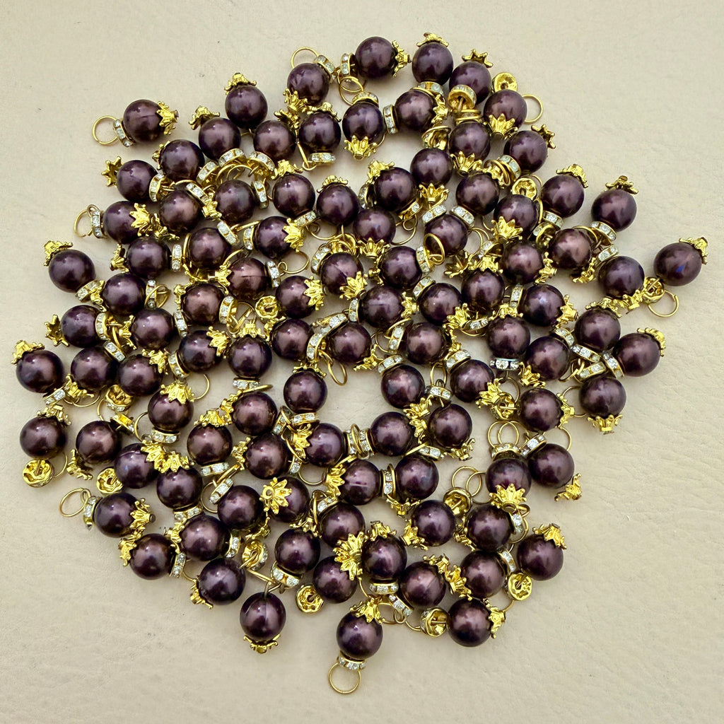 Purple pearls with gold accents on a beige background