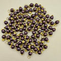 Purple pearls with gold accents on a beige background