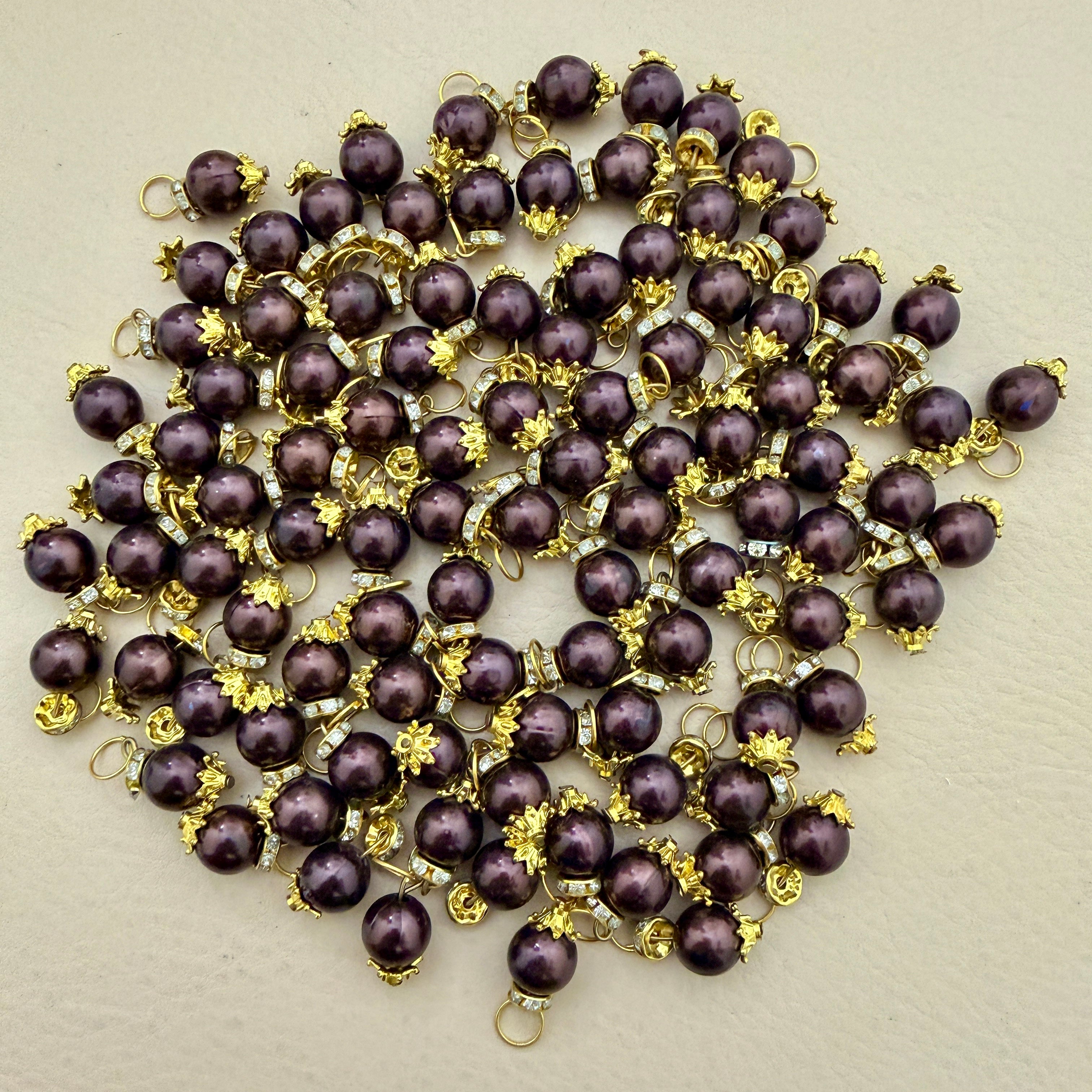 Purple pearls with gold accents on a beige background