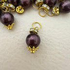 Close-up of a bracelet with purple beads and gold accents on a light background
