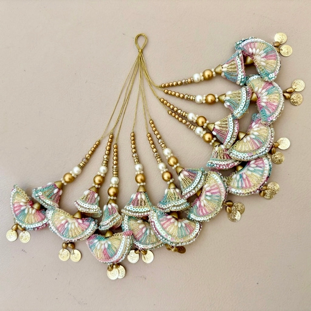 Decorative hair accessories with colorful beads and gold elements on a beige background