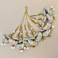 Decorative hair accessories with colorful beads and gold elements on a beige background