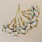 Decorative hair accessories with colorful beads and gold elements on a beige background