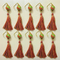 Set of tassel earrings with decorative beads on a light background