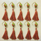 Set of tassel earrings with decorative beads on a light background