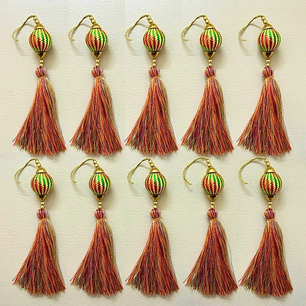 Set of tassel earrings with decorative beads on a light background