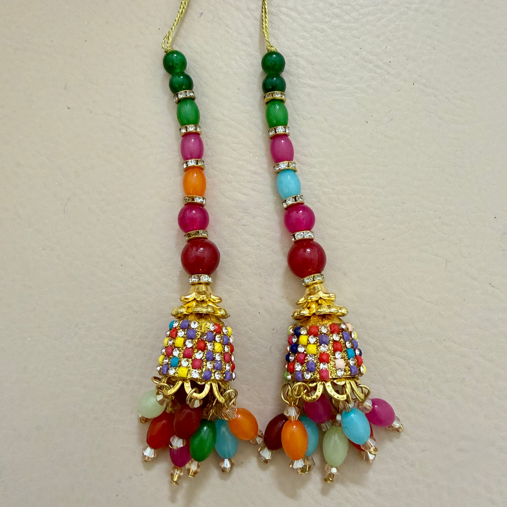 Colorful beaded earrings with gold accents on a light gray background