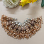 Beaded necklace with tassels on a light background