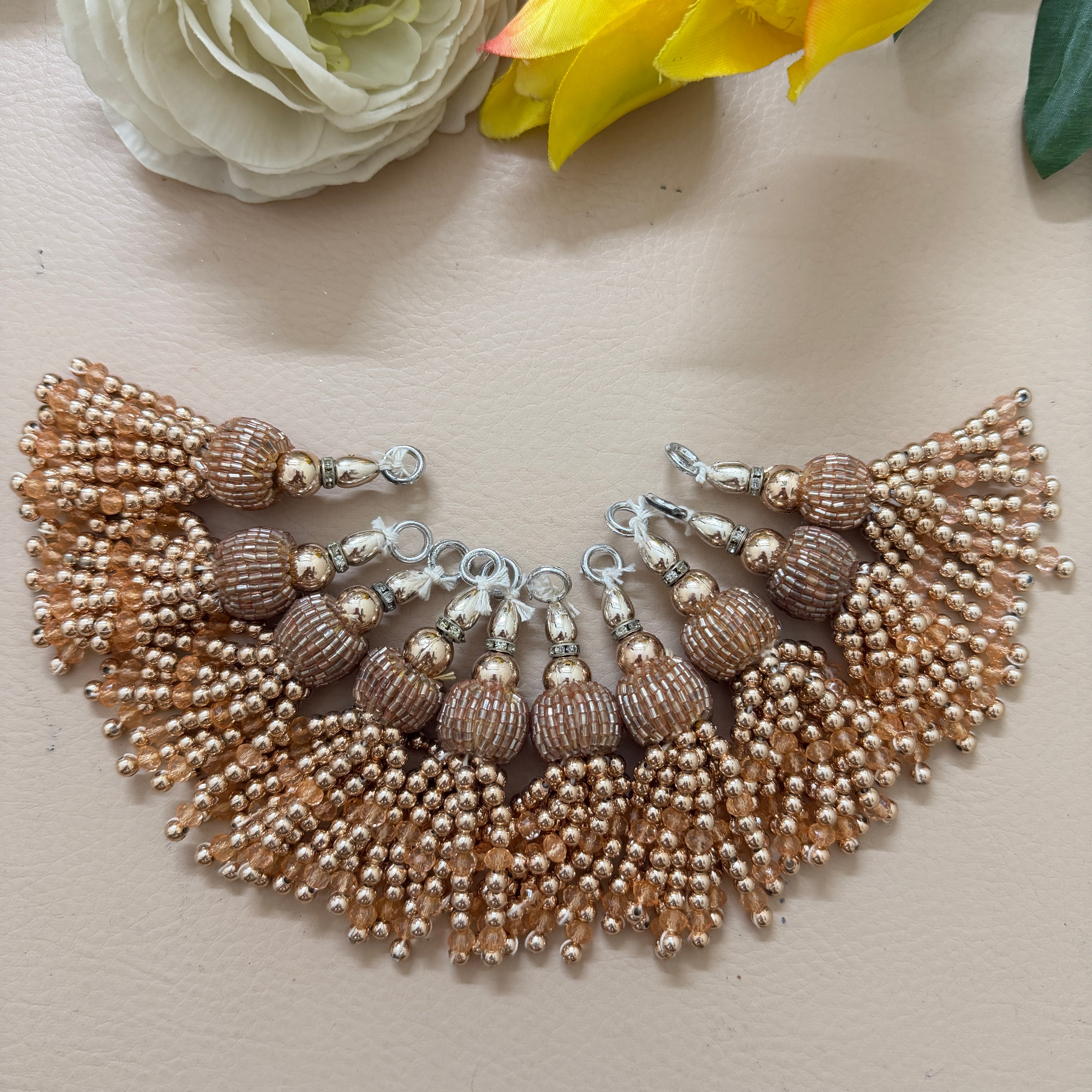 Beaded necklace with tassels on a light background