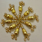 Gold and pearl decorative item on a beige background