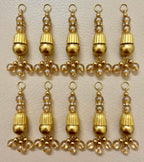 Gold and pearl beaded charms arranged in a grid on a beige background