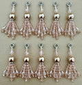 Set of beaded tassel charms on a beige background