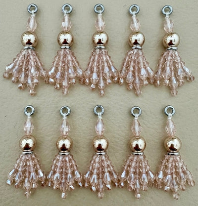Set of beaded tassel charms on a beige background
